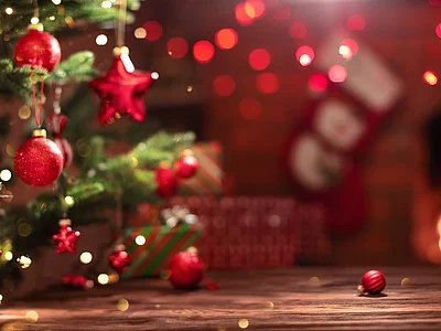 Christmas Tree with Decorations Near a Fireplace with Lights